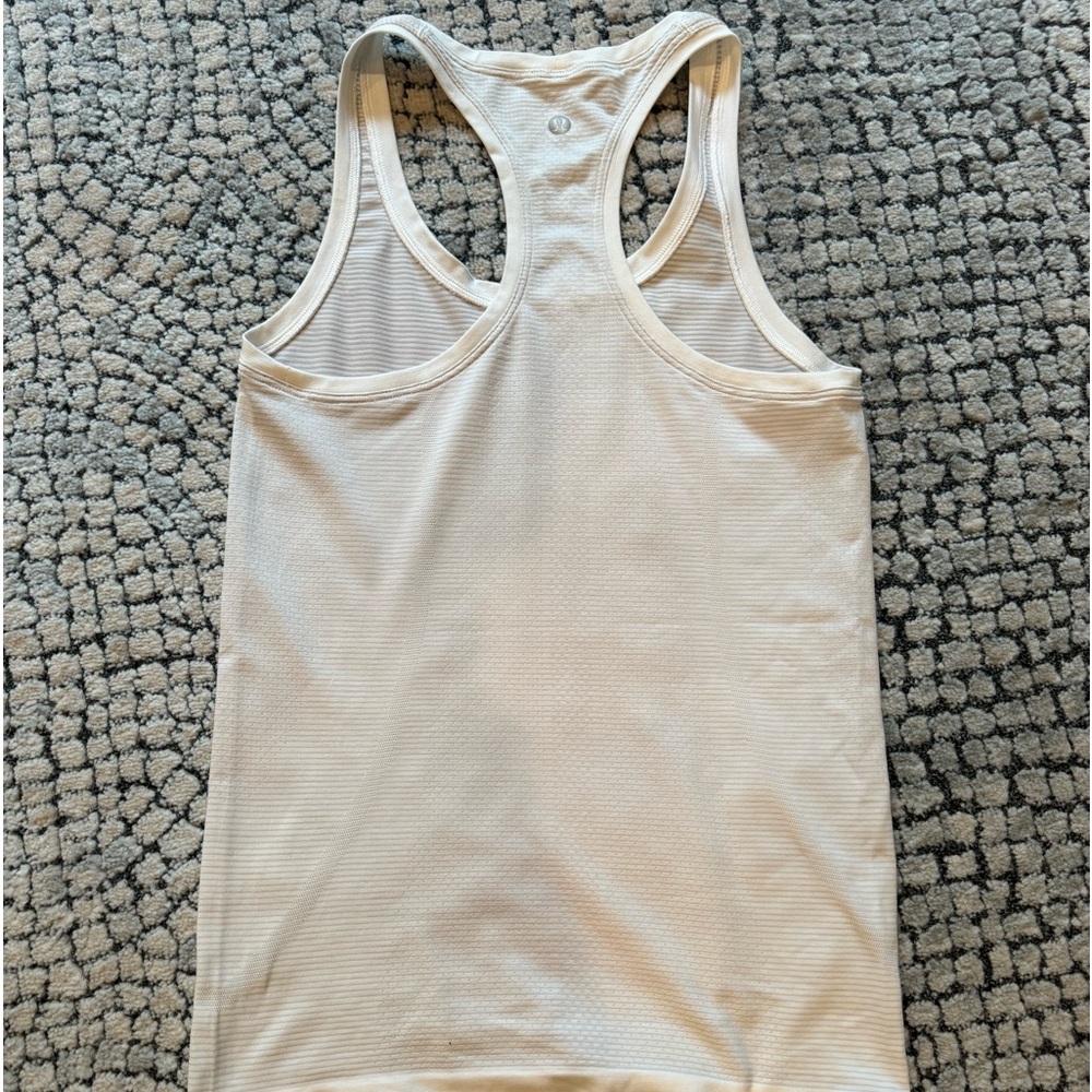 Lululemon white tank with light gray stripes. Size 4 .